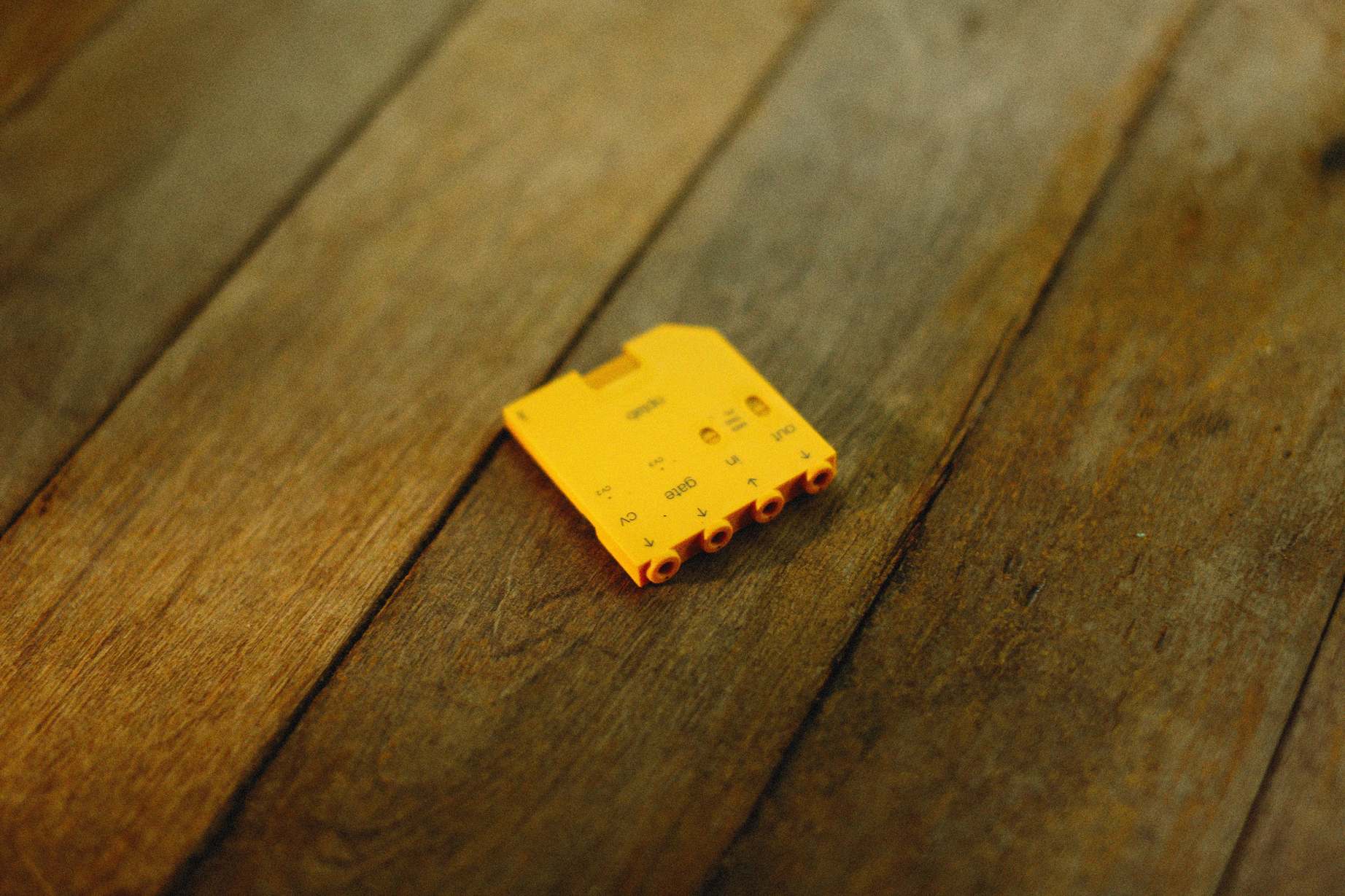 Close view of electronic circuit board texture and components, yellow electronic component on a textured surface